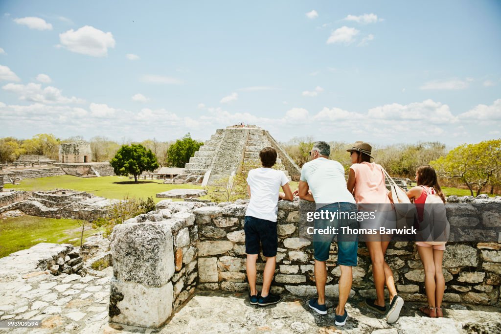 Family looking at view while exploring Mayapan ruins during vacation