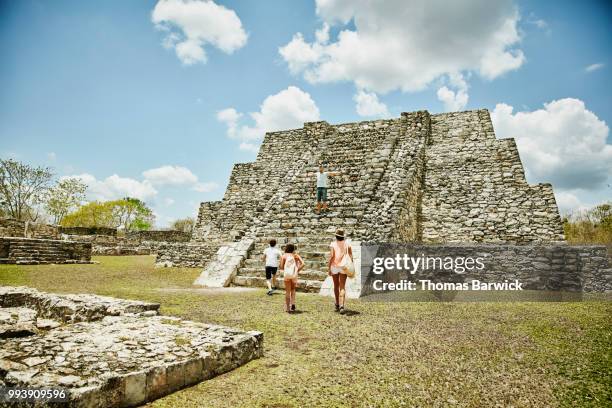 family climbing mayan ruins while on vacation - ruined clothes stock pictures, royalty-free photos & images