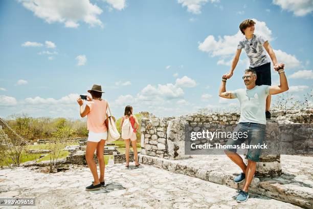 family exploring mayan ruins while on vacation - mayan ruin stock pictures, royalty-free photos & images