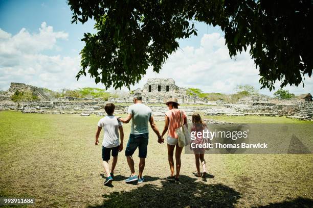 family exploring mayapan ruins during vacation - off the beaten path foto e immagini stock