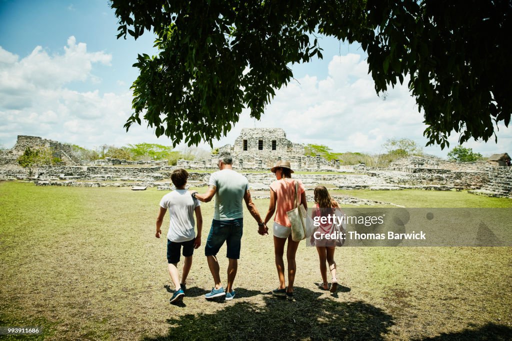 Family exploring Mayapan ruins during vacation