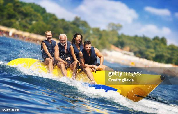 banana boat fun. - water sports stock pictures, royalty-free photos & images