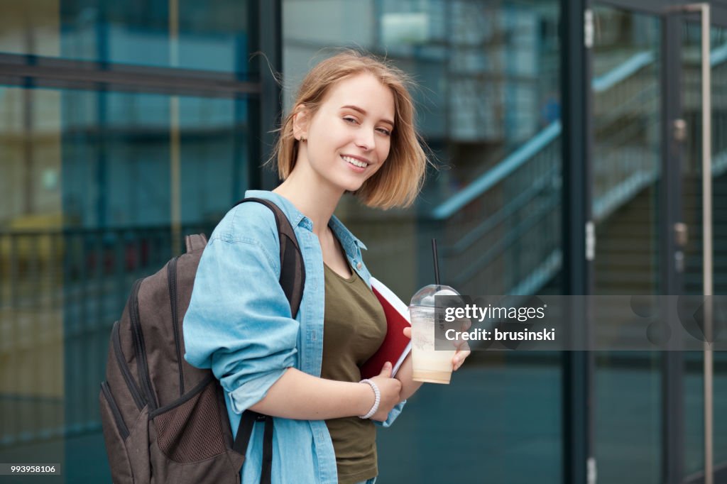 Portrait of a young attractive female student 20 years old with a backpack