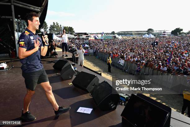 Daniel Ricciardo of Australia and Red Bull Racing entertains the crowd on the fan stage after the Formula One Grand Prix of Great Britain at...