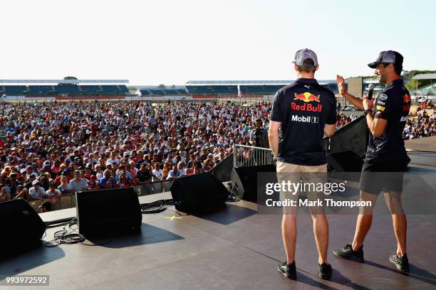 Daniel Ricciardo of Australia and Red Bull Racing and Max Verstappen of Netherlands and Red Bull Racing entertain the crowd on the fan stage after...