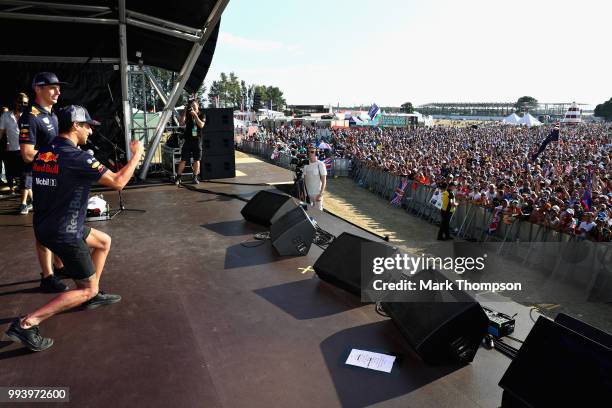 Daniel Ricciardo of Australia and Red Bull Racing and Max Verstappen of Netherlands and Red Bull Racing entertain the crowd on the fan stage after...