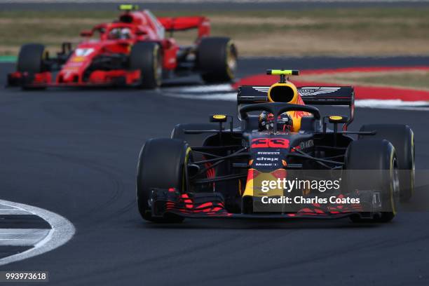 Max Verstappen of the Netherlands driving the Aston Martin Red Bull Racing RB14 TAG Heuer leads Kimi Raikkonen of Finland driving the Scuderia...