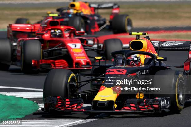 Max Verstappen of the Netherlands driving the Aston Martin Red Bull Racing RB14 TAG Heuer leads Kimi Raikkonen of Finland driving the Scuderia...