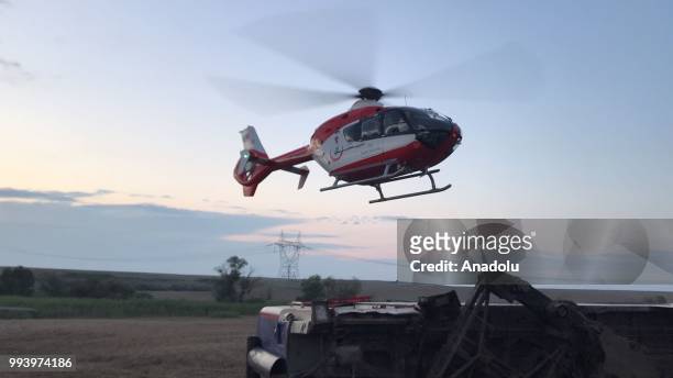 An ambulance helicopter is dispatched to the scene for the wounded passengers' transportation to hospital after several bogies of a passenger train...