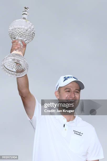 Russell Knox of Scotland celebrates with the trophy following his victory on the 18th green during a playoff at the end of the final round of the...