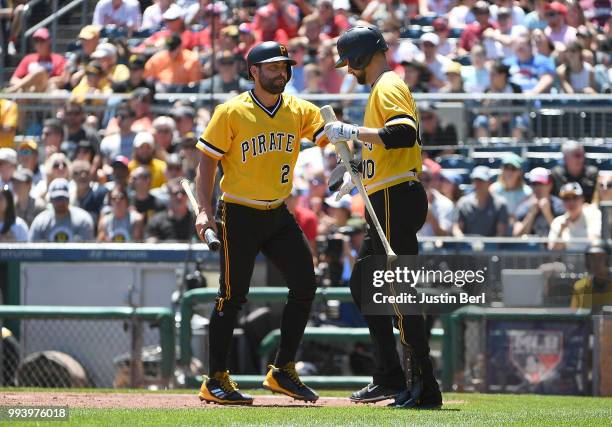 Francisco Cervelli of the Pittsburgh Pirates is met by Jordy Mercer after coming around to score on an RBI single by Josh Harrison in the second...