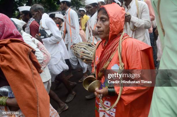 Pilgrim playing clash cymbals as Pilgrims arrive carrying palki of Saint Dnyaneshwar for annual pilgrimage from Alandi towards Pandharpur to...