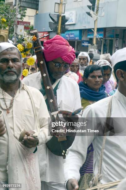 Pilgrim walking with Veena in the hand as Pilgrims arrive carrying palki of Saint Dnyaneshwar for annual pilgrimage from Alandi towards Pandharpur to...