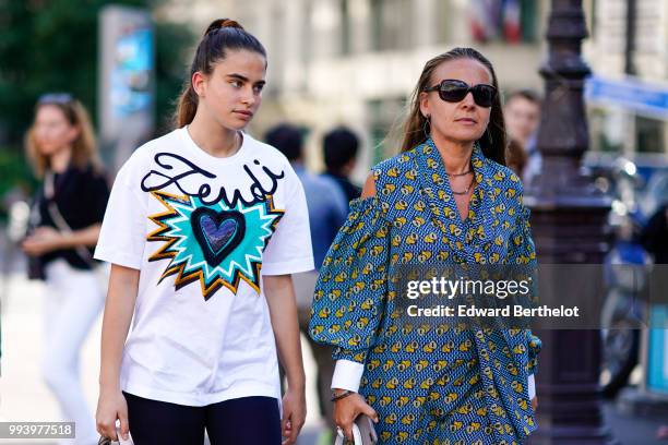 Guest wears a Fendi t-shirt with a printed blue heart, outside Fendi, during Paris Fashion Week Haute Couture Fall Winter 2018/2019, on July 4, 2018...