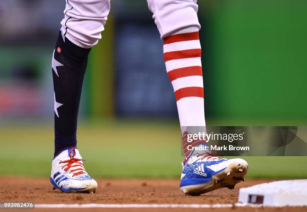 Detailed view of the Stars and Stripes edition Adidas cleats and Stance socks worn by Lewis Brinson of the Miami Marlins during the game against the...