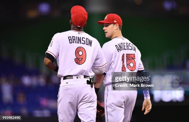 Lewis Brinson and Brian Anderson of the Miami Marlins in action against the Tampa Bay Rays at Marlins Park on July 2, 2018 in Miami, Florida.