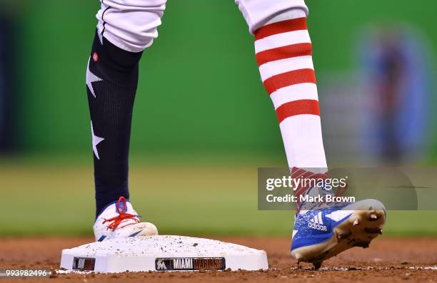 Detailed view of the Stars and Stripes edition Adidas cleats and Stance socks worn by Lewis Brinson of the Miami Marlins during the game against the...