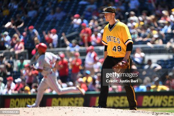 Nick Kingham of the Pittsburgh Pirates reacts as Nick Williams of the Philadelphia Phillies rounds the bases after hitting a solo home run in the...