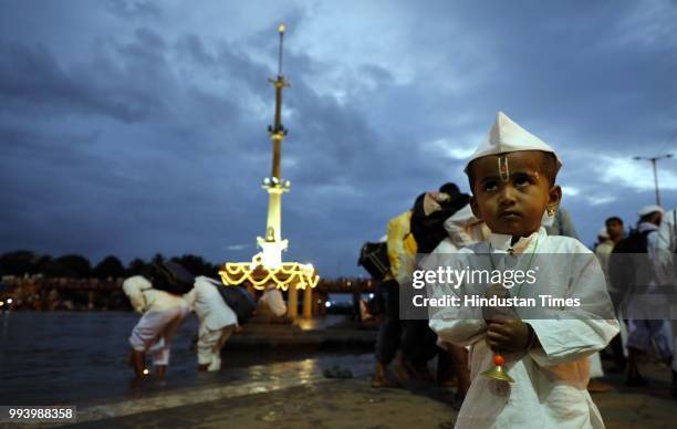 Kid devotee at Alandi Ghat bank of Indrayani river where Gyaneshwar took his Samadhi during annual pilgrimage called the Wari from Dnyaneshwar's...