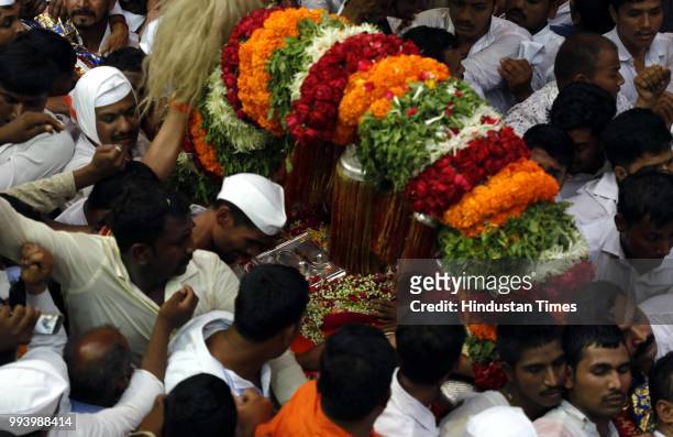 Devotees also known as warkaris carry Palkhi during annual pilgrimage called the Wari from Dnyaneshwar's shrine in Alandi to the Vitthala temple in...