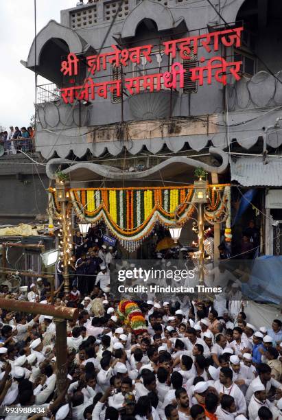 Devotees also known as warkaris carry Palkhi during annual pilgrimage called the Wari from Dnyaneshwar's shrine in Alandi to the Vitthala temple in...