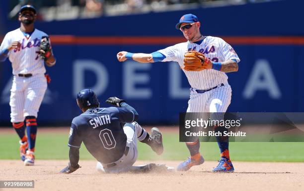 Second baseman Asdrubal Cabrera of the New York Mets gets the force on Mallex Smith of the Tampa Bay Rays and throws to first base to get Jesus Sucre...