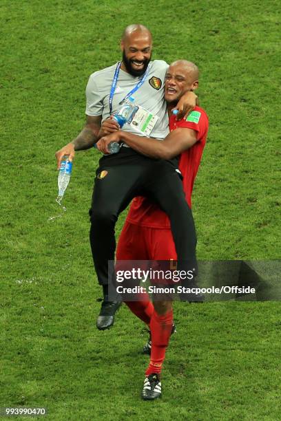 Vincent Kompany of Belgium celebrates victory with Belgium assistant coach Thierry Henry after the 2018 FIFA World Cup Russia Quarter Final match...