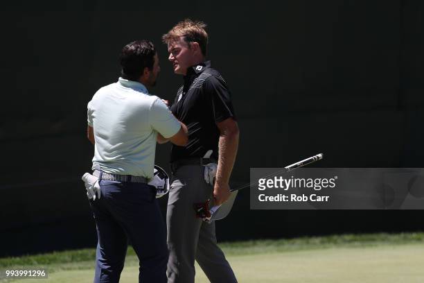 Roberto Díaz of Mexico and John Peterson shake hands after finishing the final round of A Military Tribute At The Greenbrier held at the Old White...