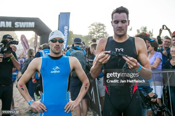 Patrick Lange of Germany and Jan Frodeno prepare for the swim leg at the Mainova IRONMAN European Championship on July 8, 2018 in Frankfurt am Main,...