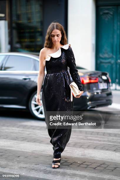Erika Boldrin wears an off-shoulder glitter black dress, a white bag , outside Valentino, during Paris Fashion Week Haute Couture Fall Winter...