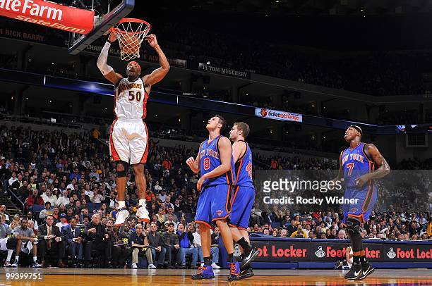Corey Maggette of the Golden State Warriors dunks against Danilo Gallinari, David Lee and Al Harrington of the New York Knicks during the game at...