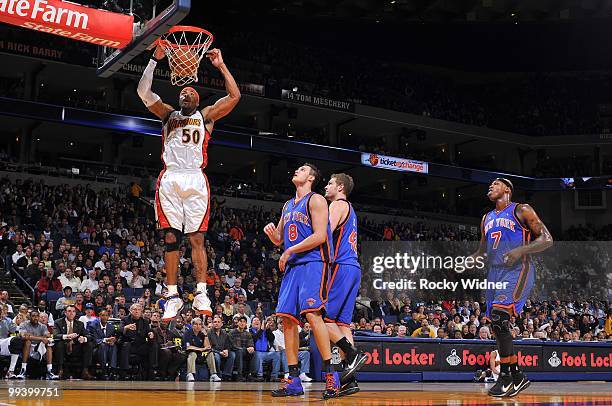 Corey Maggette of the Golden State Warriors dunks against Danilo Gallinari, David Lee and Al Harrington of the New York Knicks during the game at...