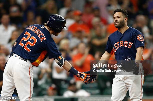 Josh Reddick of the Houston Astros cogratulates Jose Altuve after he a home run in the fourth inning against the Chicago White Sox at Minute Maid...