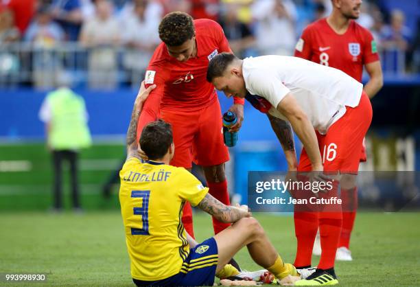 Dele Alli and Phil Jones of England console Victor Lindelof of Sweden following the 2018 FIFA World Cup Russia Quarter Final match between Sweden and...