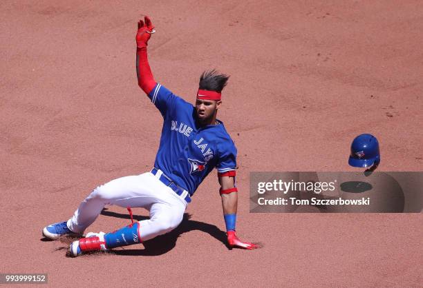 Lourdes Gurriel Jr. #13 of the Toronto Blue Jays slides into second base as he hits a double in the seventh inning during MLB game action against the...