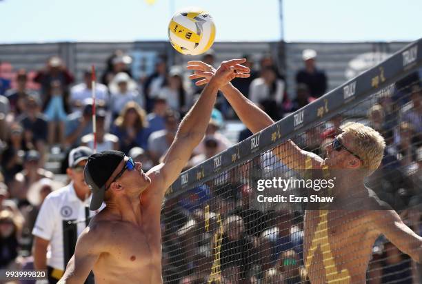 Tim Bomgren and Chase Budinger go up for ball in their semifinal match at the AVP San Francisco Open at Pier 30-32 on July 8, 2018 in San Francisco,...