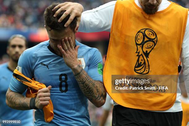 Sebastian Coates of Uruguay consoles teammate Nahitan Nandez of Uruguay following Uruguay's defeat during the 2018 FIFA World Cup Russia Quarter...