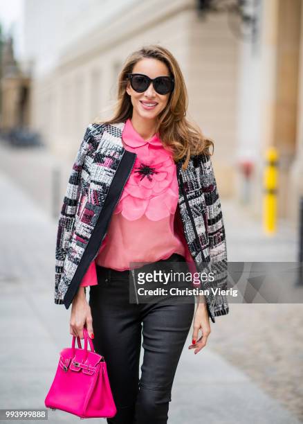 Alexandra Lapp wearing a short checked colorful jacket with zipper from Airfield, transparent pink blouse with a big flower around the neck from...
