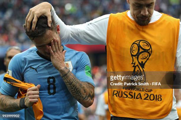 Sebastian Coates of Uruguay consoles teammate Nahitan Nandez of Uruguay following Uruguay's defeat during the 2018 FIFA World Cup Russia Quarter...