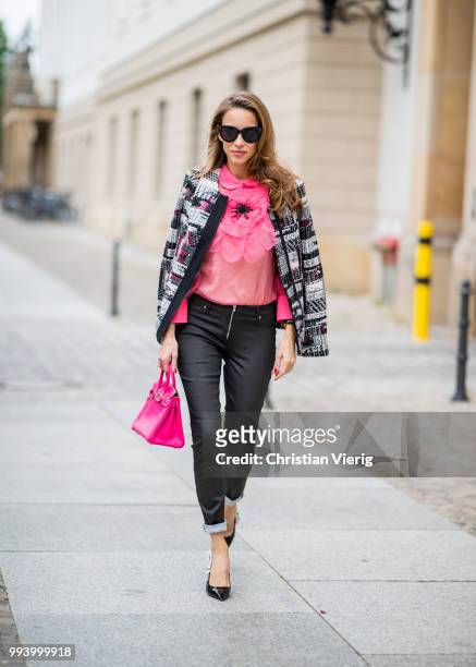 Alexandra Lapp wearing a short checked colorful jacket with zipper from Airfield, transparent pink blouse with a big flower around the neck from...
