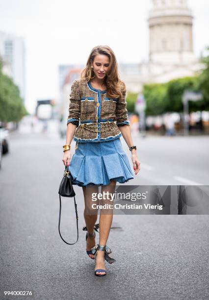 Alexandra Lapp wearing a short tweed boucle jacket with denim from Steffen Schraut, a denim shirt from H&M, a denim pleated skirt from Balmain,...