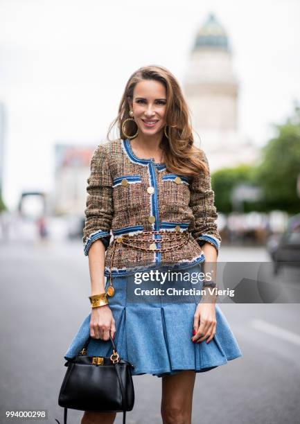 Alexandra Lapp wearing a short tweed boucle jacket with denim from Steffen Schraut, a denim shirt from H&M, a denim pleated skirt from Balmain,...