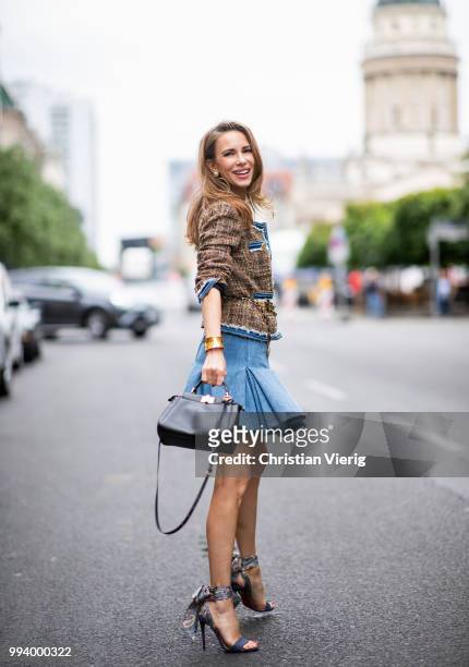 Alexandra Lapp wearing a short tweed boucle jacket with denim from Steffen Schraut, a denim shirt from H&M, a denim pleated skirt from Balmain,...