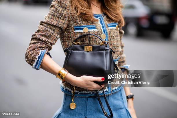 Alexandra Lapp wearing a short tweed boucle jacket with denim from Steffen Schraut, a denim shirt from H&M, a denim pleated skirt from Balmain,...