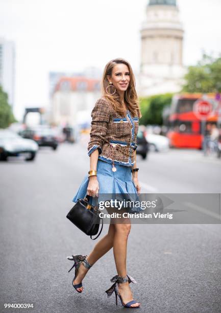 Alexandra Lapp wearing a short tweed boucle jacket with denim from Steffen Schraut, a denim shirt from H&M, a denim pleated skirt from Balmain,...