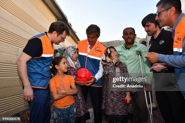 Turkish-American cardiothoracic surgeon Mehmet Oz examines Syrian Zeynep , who has a hole in her heart, during his visit in Azaz, Syria on July 8,...