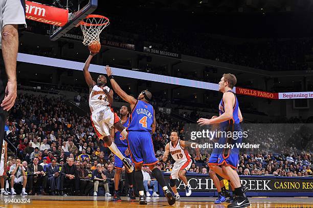 Anthony Tolliver of the Golden State Warriors shoots a layup against J.R. Giddens of the New York Knicks during the game at Oracle Arena on April 2,...