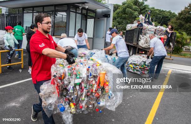 People help to collect 25 tons of plastic bottles for recycling, in eight hours, in order to set a Guinness World Record, in San Jose on July 8, 2018.