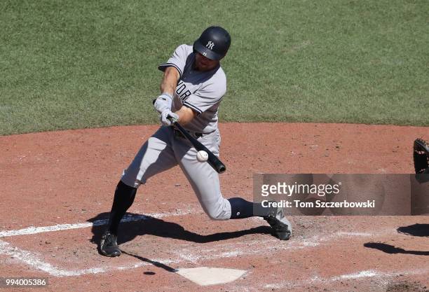 Brett Gardner of the New York Yankees hits an RBI single in the tenth inning during MLB game action against the Toronto Blue Jays at Rogers Centre on...