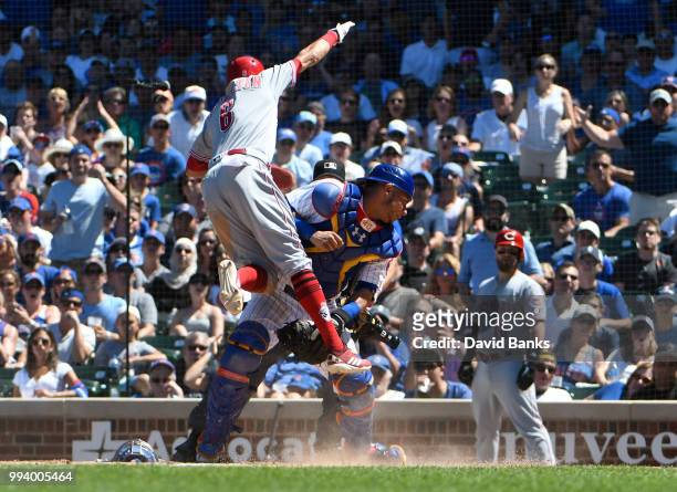 Billy Hamilton of the Cincinnati Reds is safe at home as Willson Contreras of the Chicago Cubs can't handle the throw during the fifth inning on July...